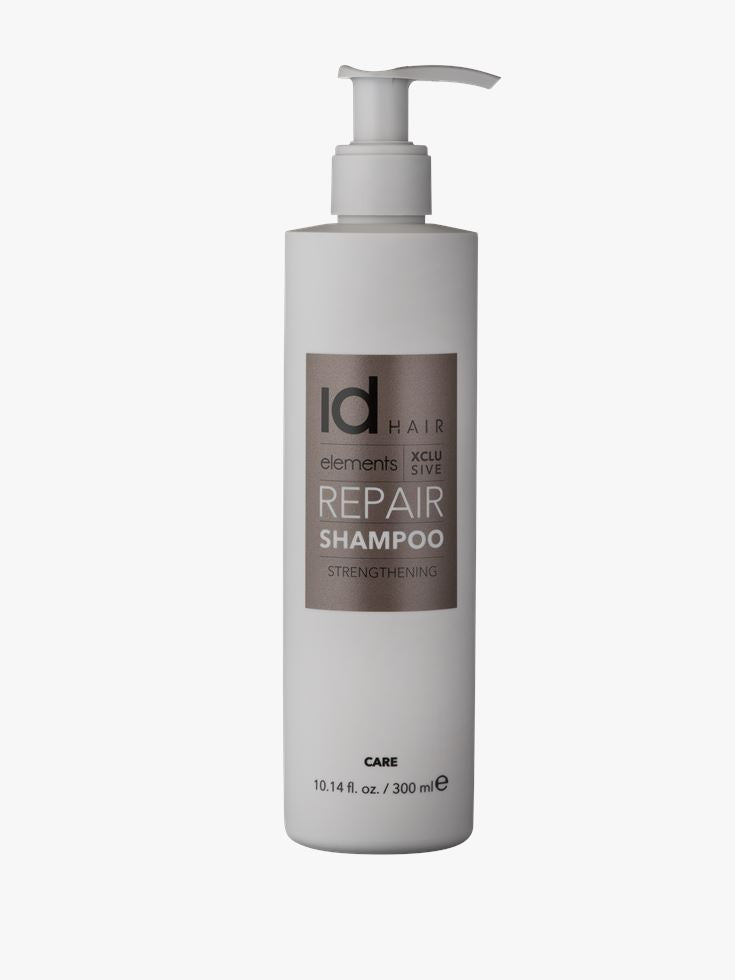 Stilsikker hvid flaske med bronze etiket og pumpe. Id Hair Repair Shampoo..