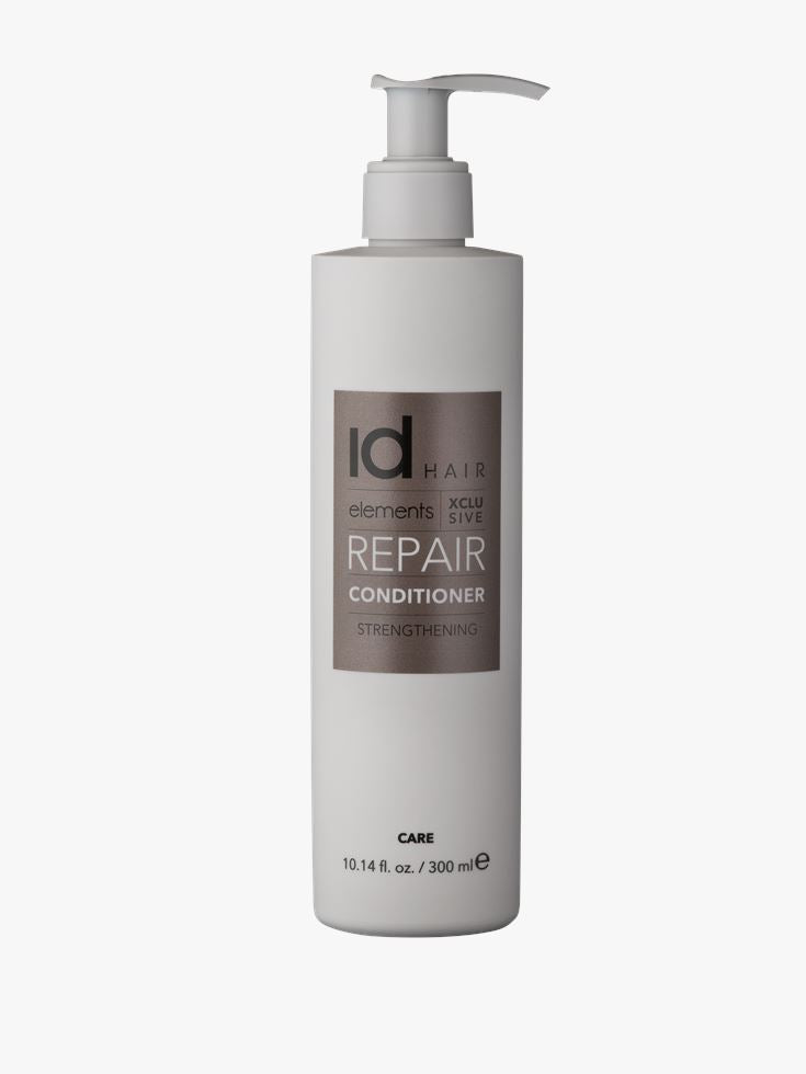 Stilsikker hvid flaske med bronze etiket og pumpe. Id Hair Repair Conditioner.